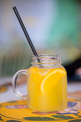 A glass of lemonade with a straw in it