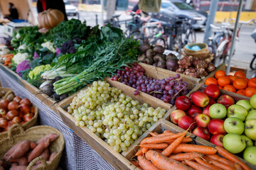 Table full of fresh fruits and vegetables, including apples, oranges