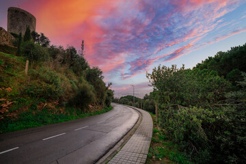Fototapeta premium Road with a beautiful sunset in the background