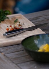 Fresh vegetables and knife on cutting board outdoors