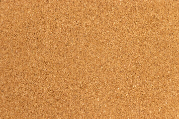 A close-up view of textured cork background, featuring its natural brown color and fine granules. Ideal for crafting, bulletin boards, and eco-friendly designs.
