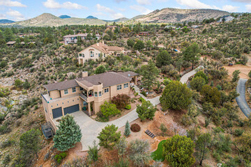 A quaint house is situated atop a hill right in the middle of a vast desert