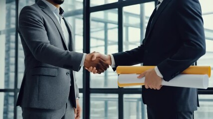 Business Deal: Two Businessmen Shaking Hands with Architectural Blueprints in Modern Office Setting, Collaboration and Partnership Agreement, Success and Professionalism - Powered by Adobe