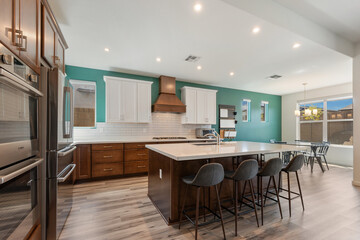 A modern kitchen with stainless steel appliances and wooden cabinets