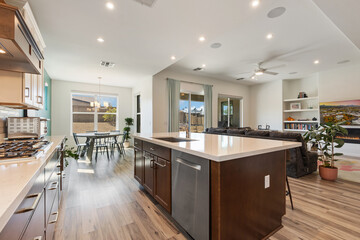 The kitchen has a large island and modern stainless steel appliances