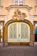 Graz, Austria – July 22, 2025: Historic residential buildings and storefronts with stucco façades and traditional wooden windows in the Old Town district of Graz under a clear summer sky.
