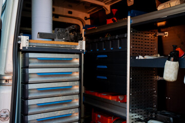 Work van interior with organized tools, drawers and shelves showing modern storage system for mechanic, technician or maintenance worker on mobile job site © K