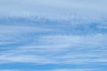 light, gentle clouds in a bright blue sky