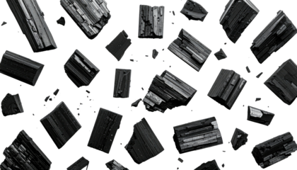 Asymmetric, blocky charcoal pieces float against a stark black backdrop, creating a dynamic, abstract arrangement