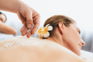 Closeup blissful couple customer having exfoliation treatment in luxury spa salon with warmth...