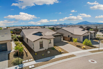 aerial perspective of current suburban house with desertthemed yard and scenic mountain background