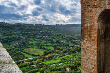 2019-11-01 A VIEW OF A LUSH VALLEY IN THE TOWN OF ORVIETO ITALY IN THE TUSCANY REGION FROM THE EDGE OF A TOWER AND LEDGE