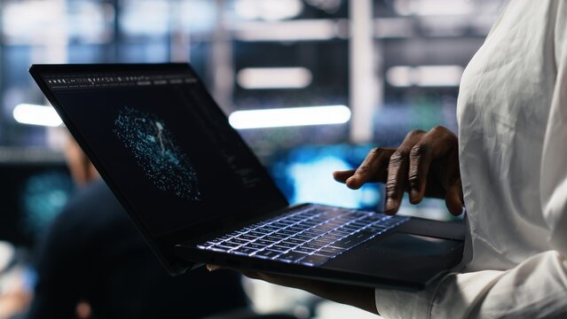 Close up of data center technician using tablet to monitor neural network AI LLM visualization. Worker using large language model on device to oversee servers powering machine learning, camera A - Powered by Adobe