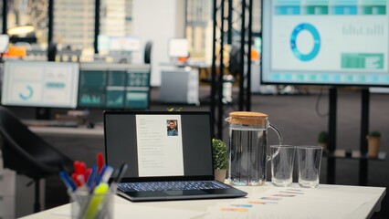 Empty startup space with a laptop running CV applicant before job interview, space used for the recruitment process and reviewing qualifications or past work experience to align with vacancy.