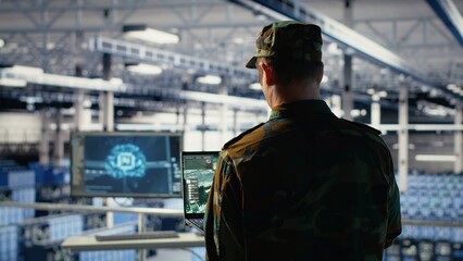 Fototapeta premium Military data center expert using ballistic missiles radar on laptop to watch for enemy threats. Army soldier in data center uses scanner tech to detect rockets launched by enemy troops, camera B