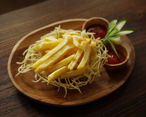Crispy French Fries with Ketchup and Mayonnaise Served on Wooden Plate