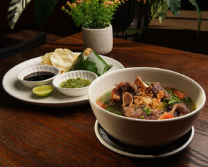 Traditional Indonesian Oxtail Soup or Sop Buntut Served in White Bowl