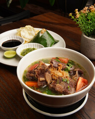 Traditional Indonesian Oxtail Soup or Sop Buntut Served in White Bowl