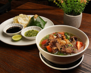 Traditional Indonesian Oxtail Soup or Sop Buntut Served in White Bowl
