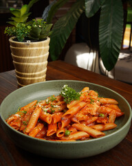Italian Penne Pasta with Tomato Sauce and Parmesan Cheese Served in Ceramic Bowl