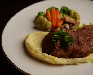 Grilled Beef Steak with Mashed Potatoes and Steamed Vegetables on Ceramic Plate