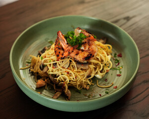 Spaghetti Aglio Olio with Grilled Shrimp and Mushroom Served in Green Ceramic Bowl