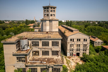 Abandoned distillery tower in Italy – circular industrial building with glass dome, steel beams, panoramic windows, decaying factory interior, urban exploration, post-industrial architecture