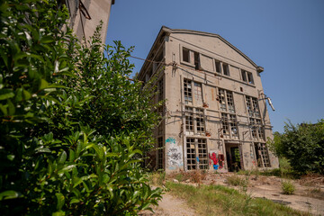 Abandoned distillery tower in Italy – circular industrial building with glass dome, steel beams, panoramic windows, decaying factory interior, urban exploration, post-industrial architecture