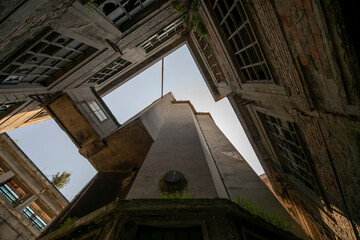 Abandoned distillery tower in Italy – circular industrial building with glass dome, steel beams, panoramic windows, decaying factory interior, urban exploration, post-industrial architecture