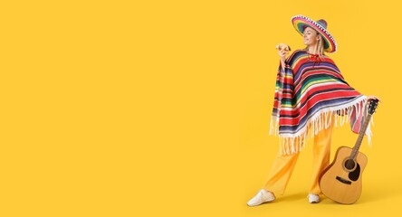 Young woman in Mexican clothes holding tasty taco and guitar on yellow background with space for text