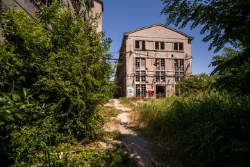 Abandoned distillery tower in Italy – circular industrial building with glass dome, steel beams, panoramic windows, decaying factory interior, urban exploration, post-industrial architecture