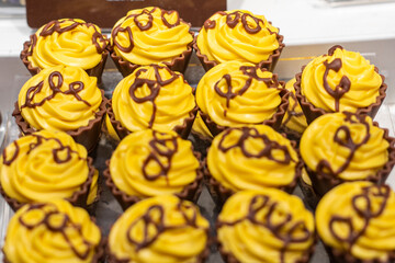 German chocolate-covered milk chocolates with yellow fondant on top.