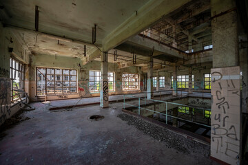 Abandoned distillery tower in Italy &ndash; circular industrial building with glass dome, steel beams, panoramic windows, decaying factory interior, urban exploration, post-industrial architecture
