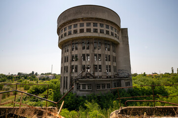 Abandoned distillery tower in Italy – circular industrial building with glass dome, steel beams, panoramic windows, decaying factory interior, urban exploration, post-industrial architecture