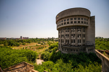 Abandoned distillery tower in Italy – circular industrial building with glass dome, steel beams, panoramic windows, decaying factory interior, urban exploration, post-industrial architecture