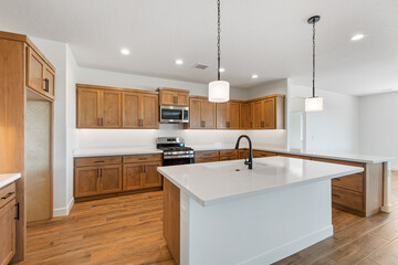A beautiful kitchen featuring wooden cabinets along with a spacious island