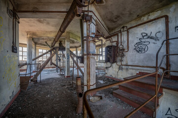 Abandoned distillery tower in Italy – circular industrial building with glass dome, steel beams, panoramic windows, decaying factory interior, urban exploration, post-industrial architecture