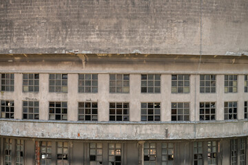 Abandoned distillery tower in Italy – circular industrial building with glass dome, steel beams, panoramic windows, decaying factory interior, urban exploration, post-industrial architecture