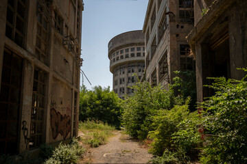 Abandoned distillery tower in Italy – circular industrial building with glass dome, steel beams, panoramic windows, decaying factory interior, urban exploration, post-industrial architecture