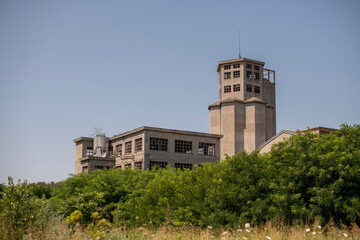 Abandoned distillery tower in Italy – circular industrial building with glass dome, steel beams, panoramic windows, decaying factory interior, urban exploration, post-industrial architecture