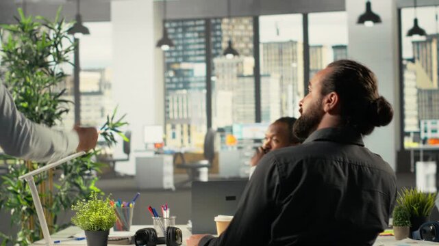 Corporate conference with investors group discussing performance reports, insights and planning. Professional team evaluates financial data and forecasting for targets. Camera B. - Powered by Adobe