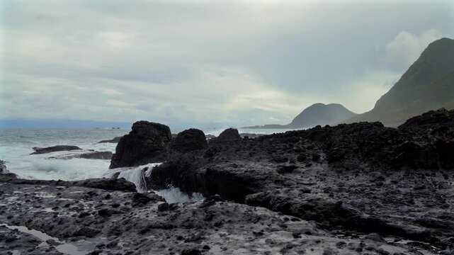 Hualian Shimen Sea Erosion Cave, Shimen Cave (March Cave), Taiwan. Waves crash against the rocks