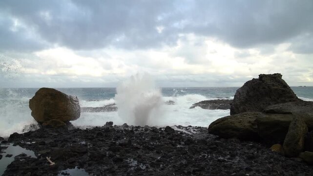 Hualian Shimen Sea Erosion Cave, Shimen Cave (March Cave), Taiwan. Waves crash against the rocks