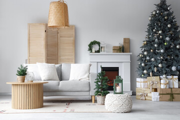 Interior of modern living room with fireplace decorated for Christmas