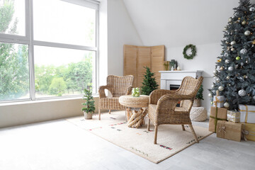 Interior of modern living room with fireplace decorated for Christmas