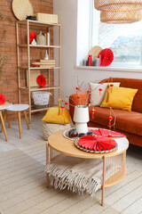 Interior of living room with sofa, table and decor for Chinese New Year celebration