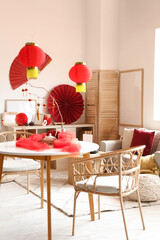 Interior of room with sofa, dining table and decor for Chinese New Year celebration