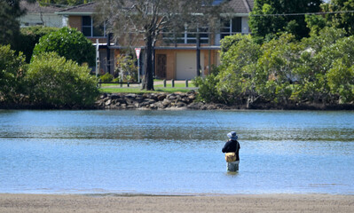 Australians active senior fisherman fishing in river