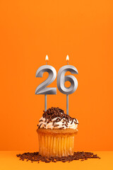 Birthday candle number 26 - Invitation card with orange background. Cupcake