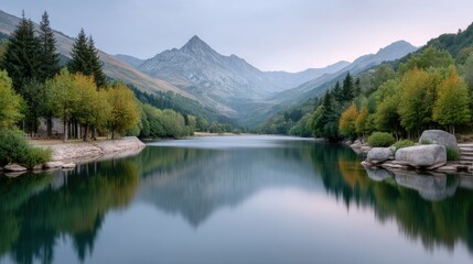 Fototapeta premium Serene Lake Reflects Majestic Mountains And Autumn Trees Under A Hazy Sky Long Exposure Photography